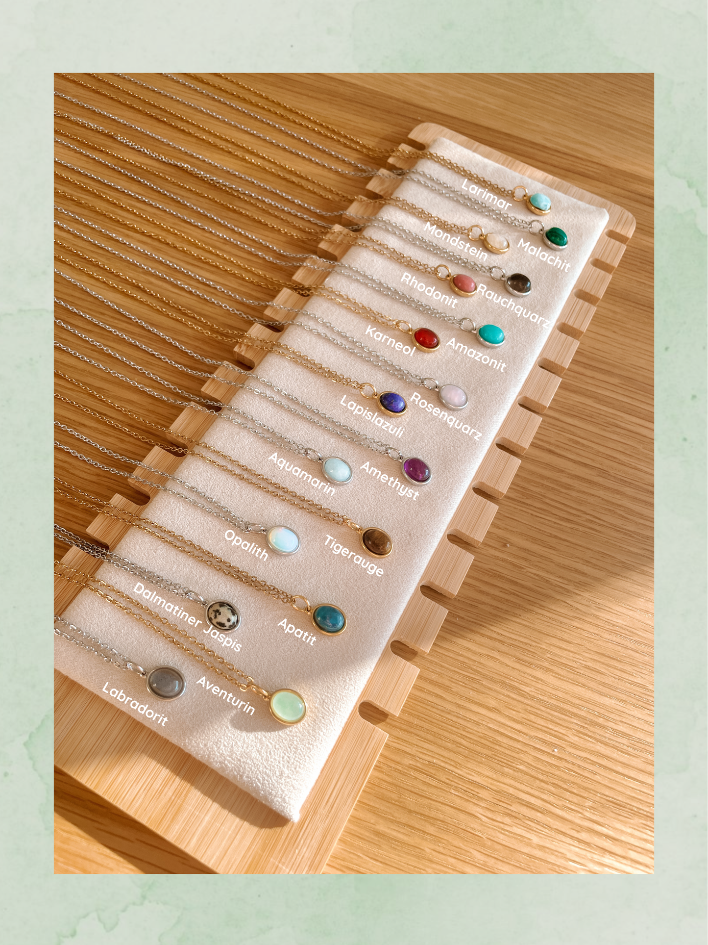 Verschiedene Edelsteine auf einer Präsentationsfläche, darunter Malachit, Tigerauge und Lapislazuli. Studiocafe-Gliederketten.