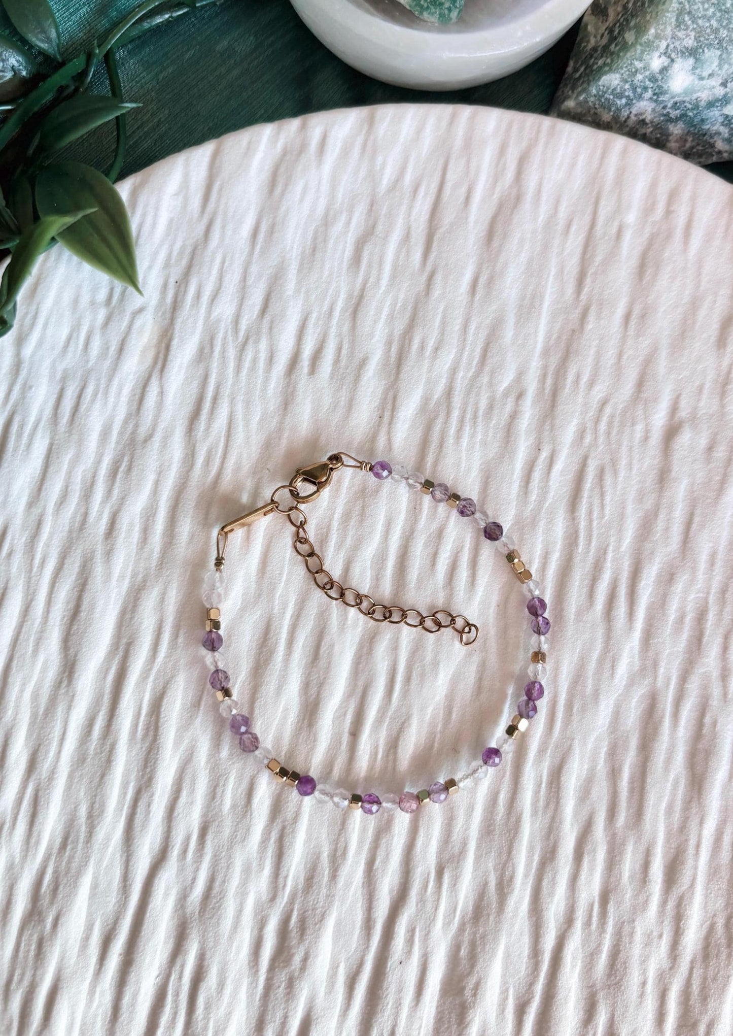 Goldenes Edelstein Armband mit Rosenquarz und Amethyst Perlen liegend auf weißem Tablett, Ansicht von oben